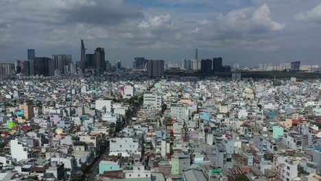 Aerial-panoramic-tracking-shot-of-dense-urban-area-of-Ho-Chi-Minh-City,-Vietnam-on-a-sunny-day-with-all-key-buildings-of-the-skyline