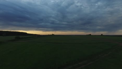 rural landscape at sunset with storm clouds