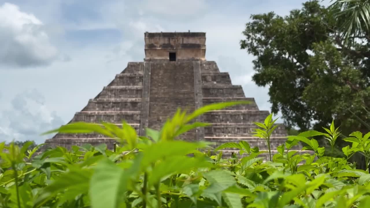 Handheld long lens booming up shot of the Mayan pyramid El Castillo at Chichen Itza in Yucatan, Mexico. 4K