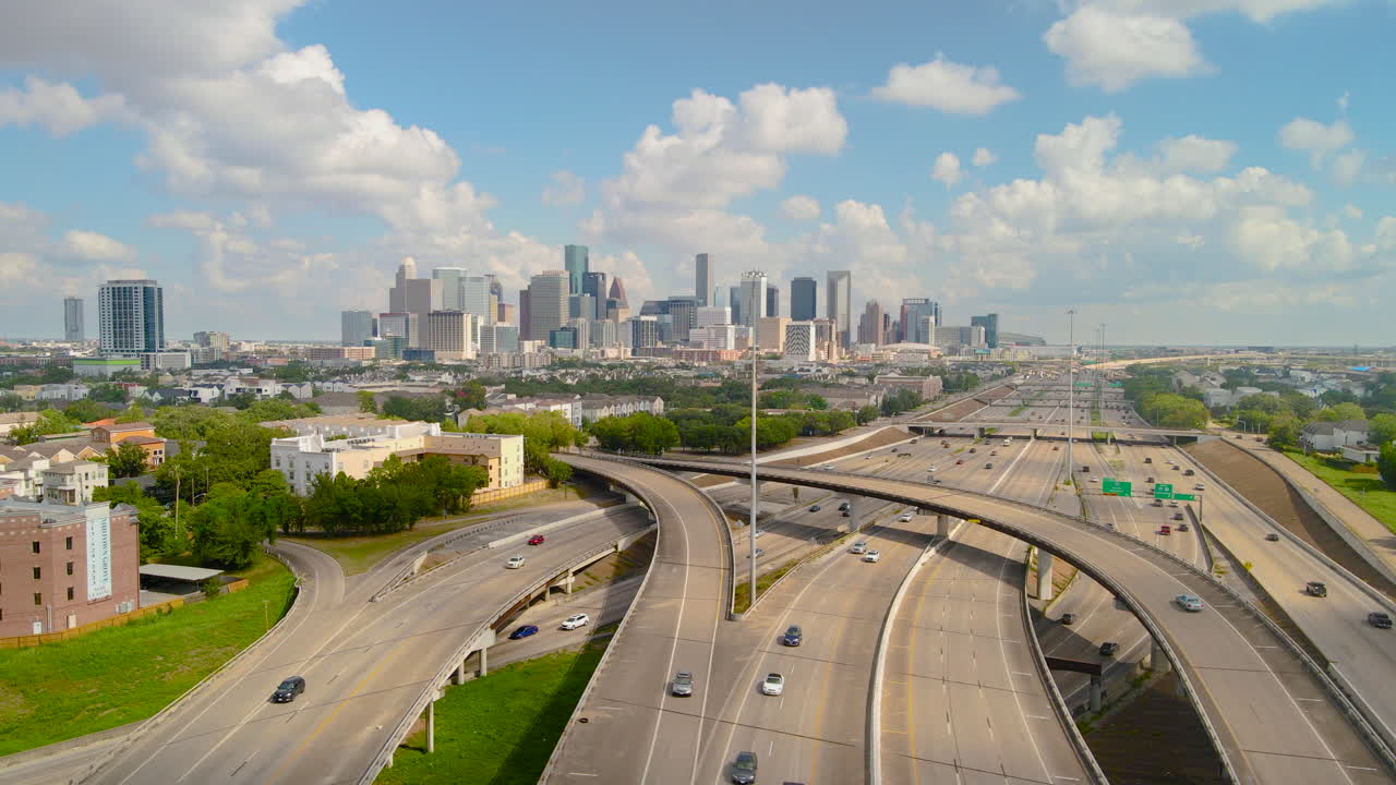 Parallax Drone shot Interstate Texas highway 288 Downtown Houston Texas. Daylight Intro aerial shot Houston Downtown. Aerial highway 288 and interstate 69 intersection overlooking downtown Houston