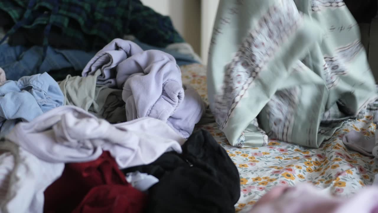 A pile of laundry on a bed