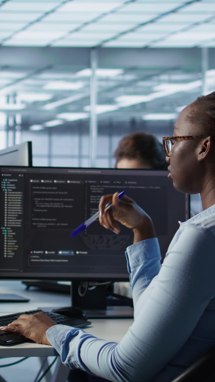 African American Woman Programmer Working on Code in Office