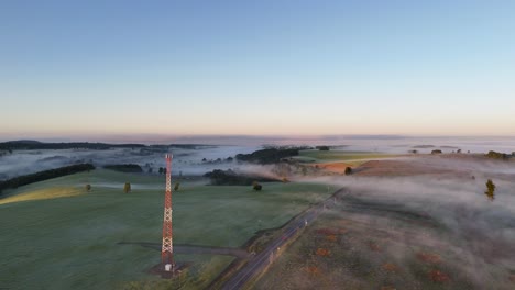 Descending-aerial-panorama-over-a-misty-meadow-landscape