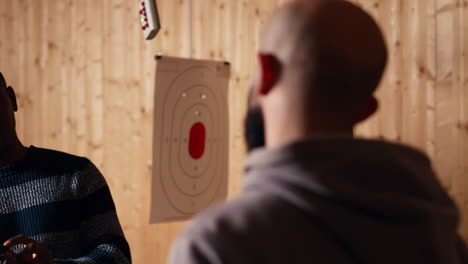 shooting range safety officer shows how to reload pistol, following regulations