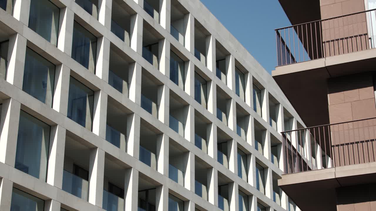 Contemporary residential buildings featuring geometric windows, angular balconies and mixed designs