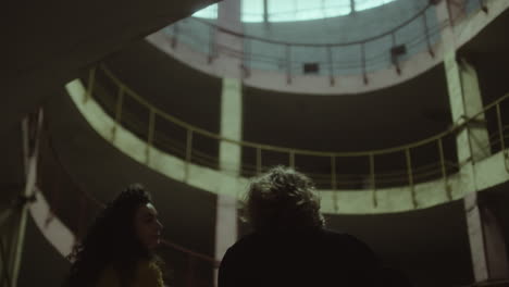 two women in dark abandoned building
