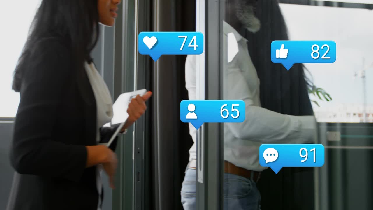 Donna che passa accanto a un vetro, causando dei suoni intorno a un uomo che cammina con un tablet, i cui conteggi aumentano, mostrando statistiche social.