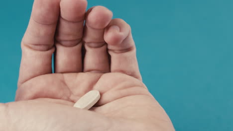 hand taking pill from package