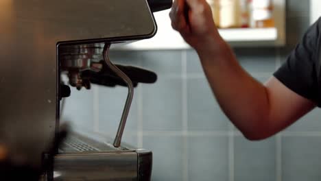 barista using coffee machine