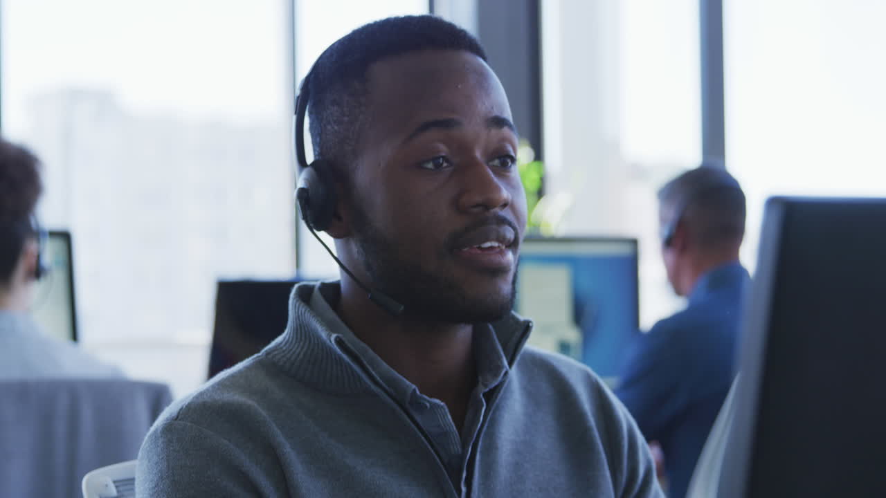 Young man with headset working on computer