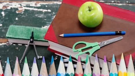 Animation-of-pencils-over-school-items-on-wooden-table