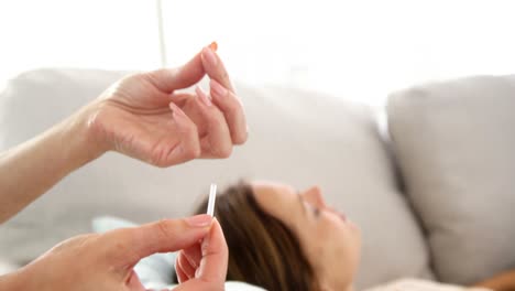 acupuncturist holding a needle behind her patient