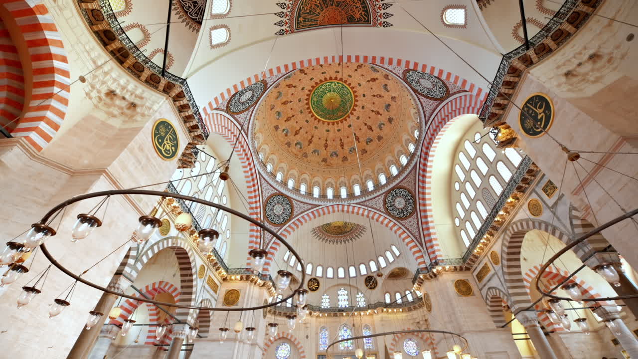 Interior view of the Suleymaniye mosque in Istanbul, Turkey. A lot of illumination, painted ceiling