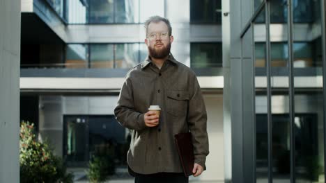 man with coffee in urban setting