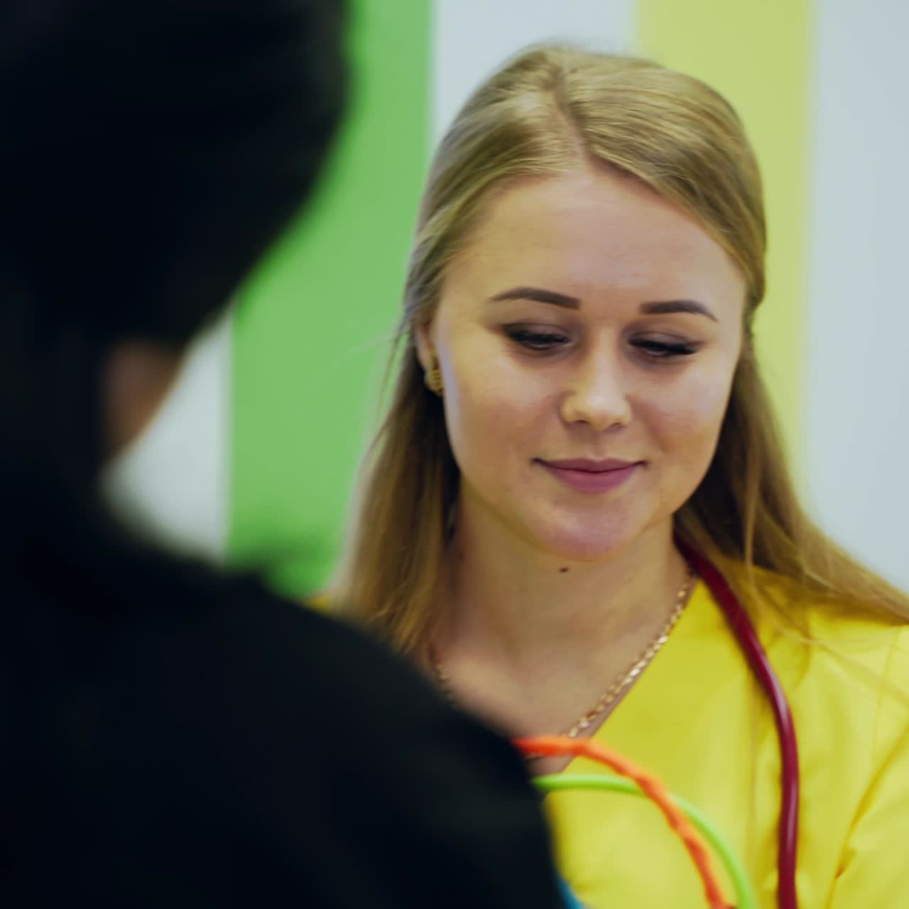 Pediatrician doctor examining child. Young female pediatrician examining cute little patient