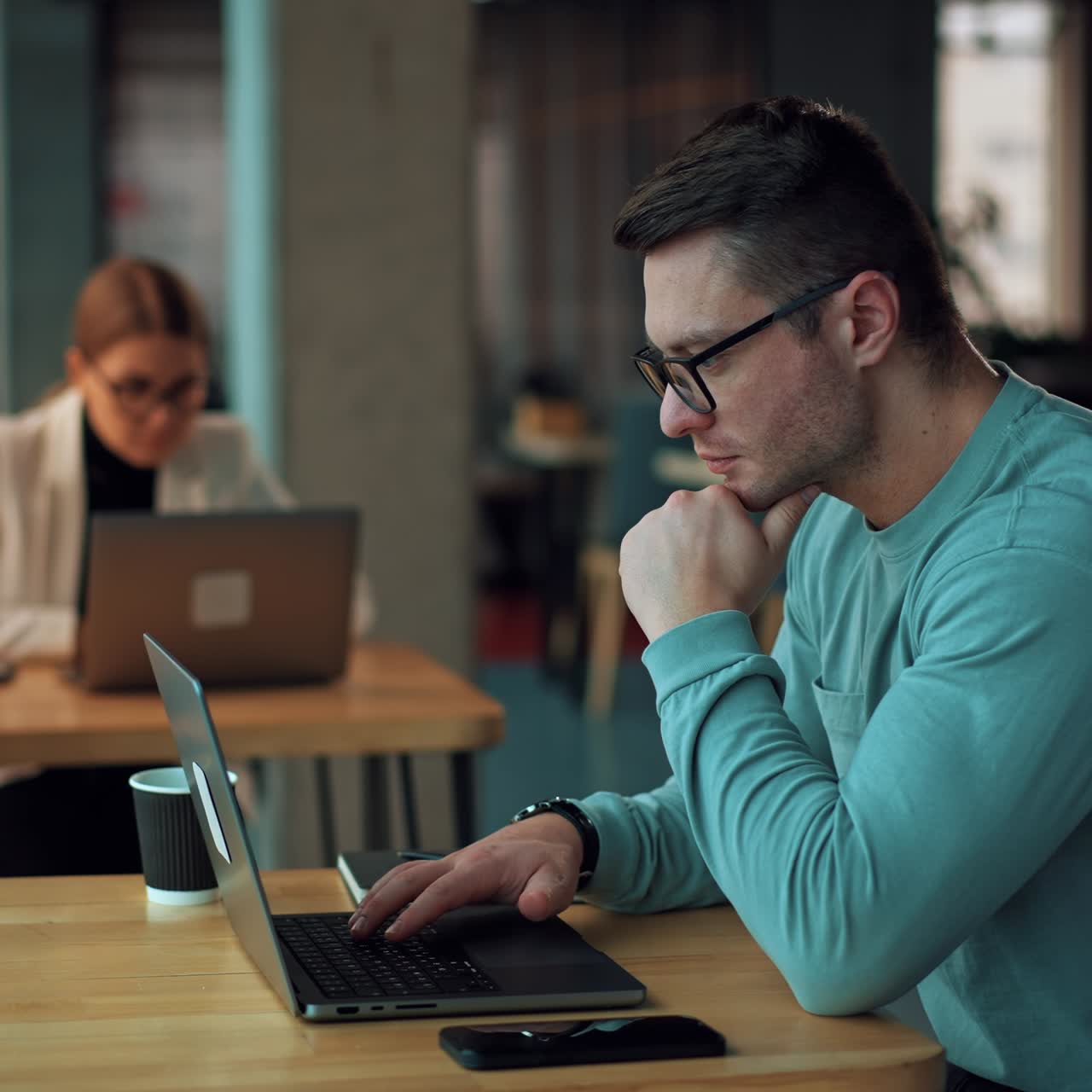 Smart businessman in cafe working. Handsome young business manager working with laptop