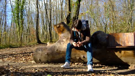 young man sitting autumn forest