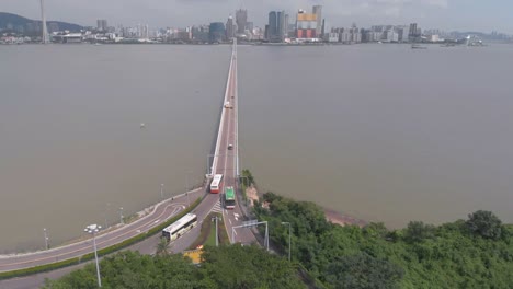 aerial drone shot tilt reveal of macau skyline and praia grande bridge
