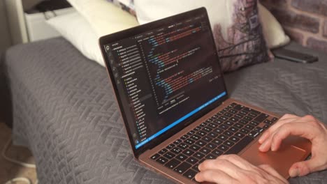 a student scrolls past code for website development on a laptop computer on a modern programming editor