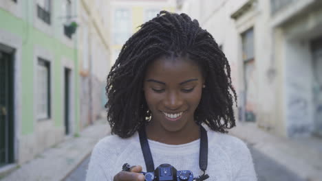 closeup shot of female photographer taking pictures on city street.