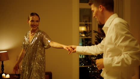 Carefree-pair-dancing-at-New-Year-celebration-home-closeup.-Couple-holding-hands