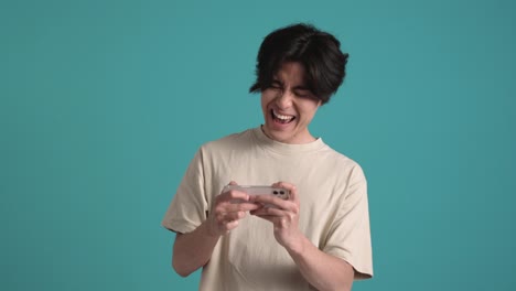 smiling asian man playing in digital game