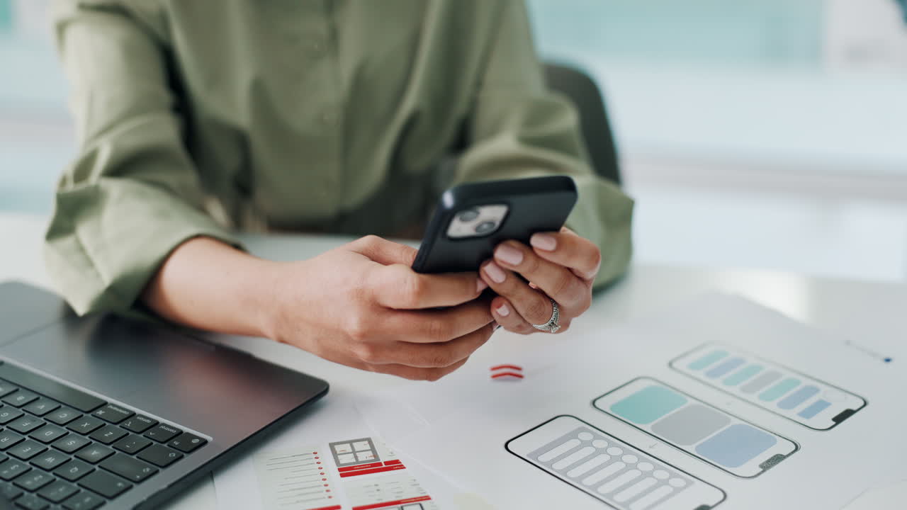 Woman using smartphone at desk