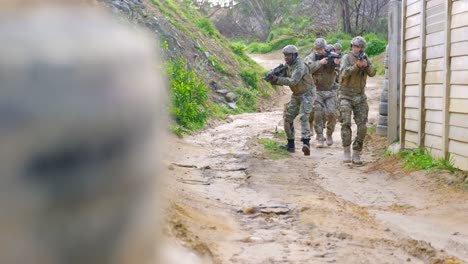 Front-view-of-mixed-race-military-soldiers-rifle-training-in-fields-during-military-training-4k-