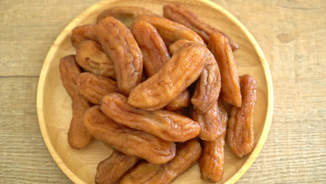 sun dried banana on wooden plate