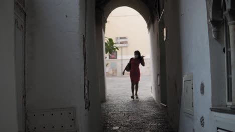 lonely woman with face mask walking on streets and passage in amalfi city italy