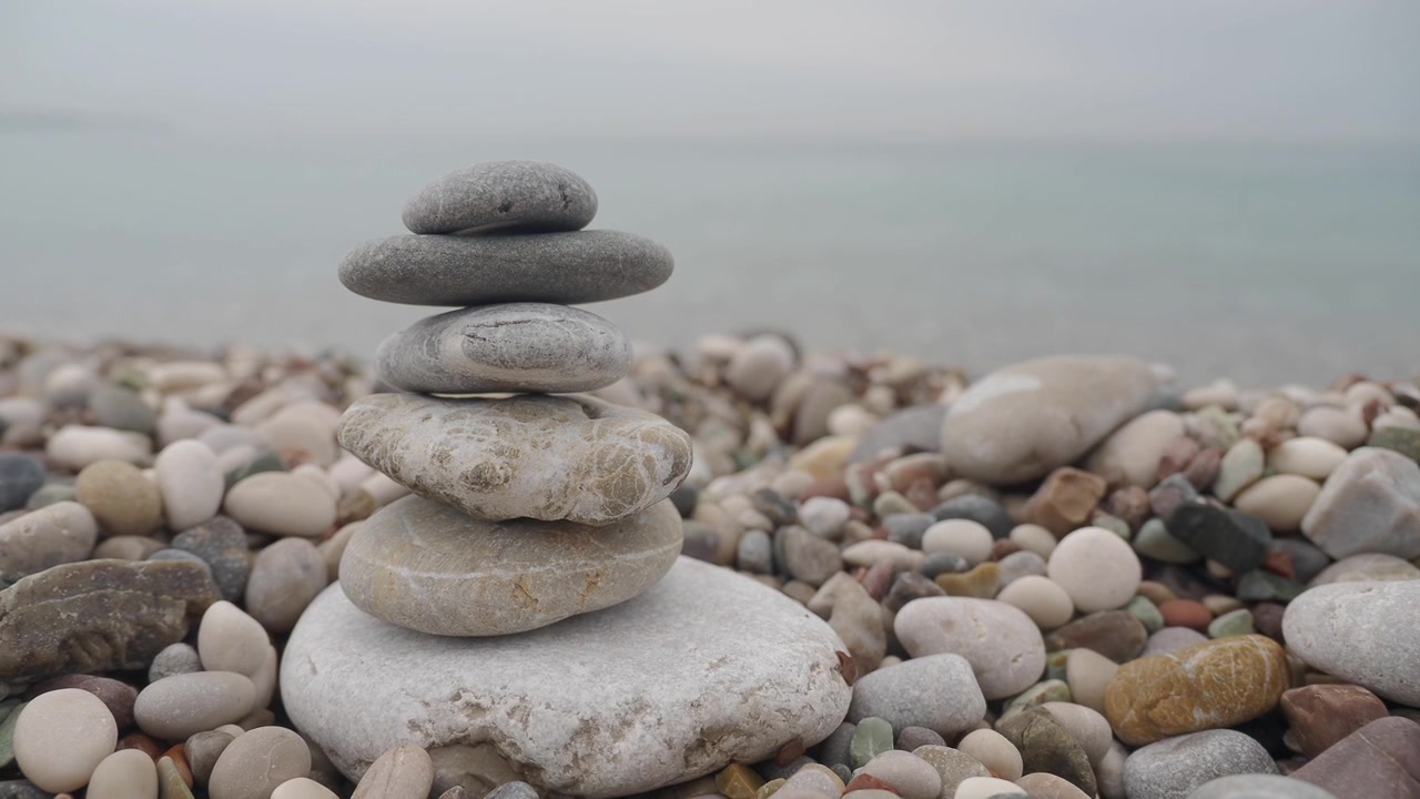 Balanced Stone Stack on a Pebble Beach by the Sea