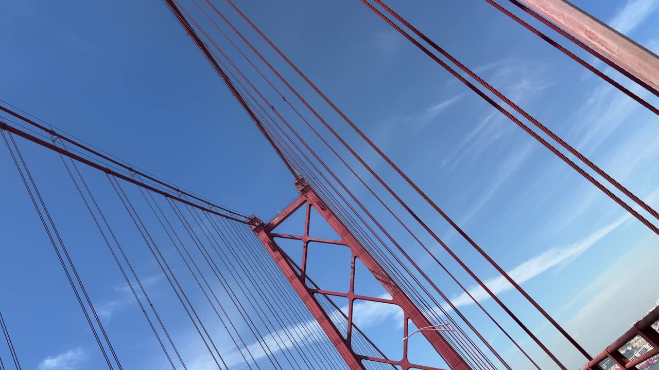 Architectural Details of a Red Suspension Bridge Against Blue Sky