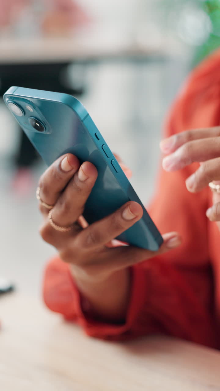 Close-up of a Person's Hands Using a Blue Smartphone