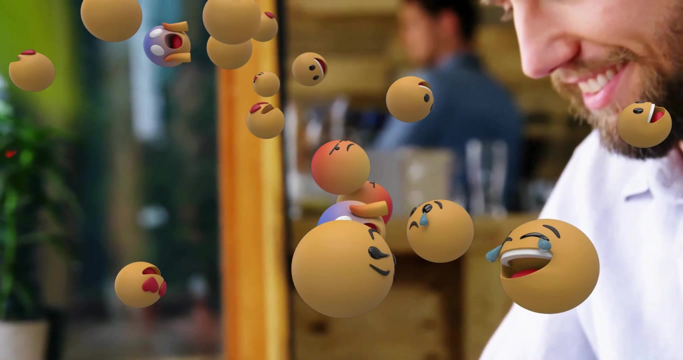 Café patron tapping smartphone generating emoticon bubbles illustrating social media engagement