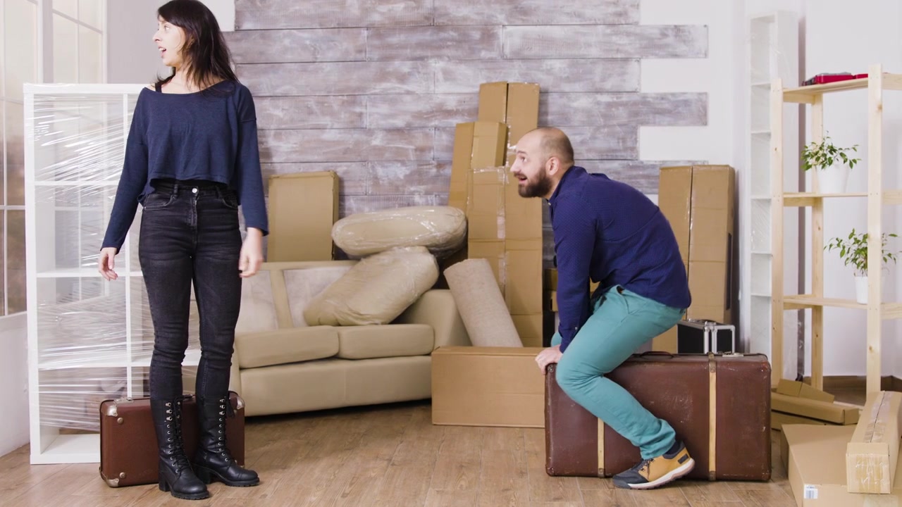Couple Taking a Break While Moving Into a New Home