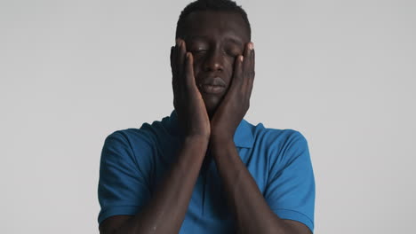 incredulous african american man on grey background.