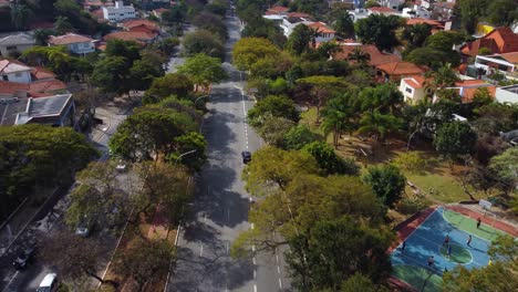 flying down the avenue, streets with traffic as the sao paulo skyline slowly appears