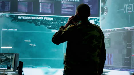 Military-man-answers-phone-call-in-a-mission-control-center