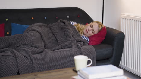 woman sleeping on couch with blanket