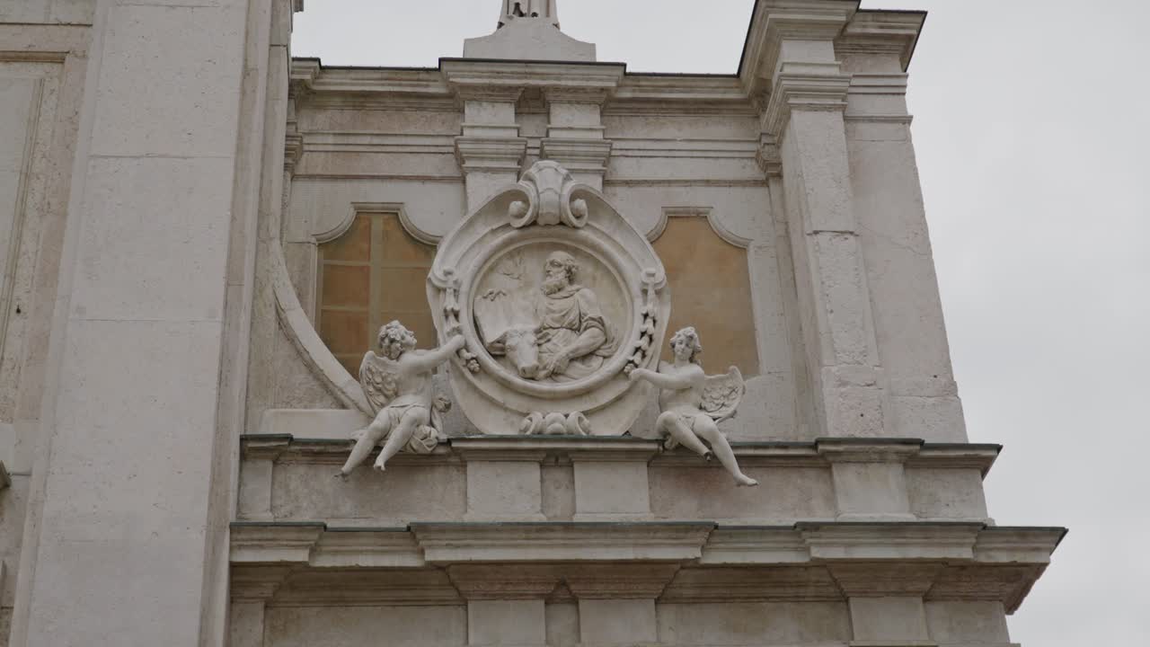 Tranquil Scenic View Of Saint Luke Statue On The Facade Of Mantua Cathedral On A Cloudy Day In Mantova, Italy. low-angle
