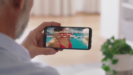 mature-man-having-video-chat-using-smartphone-waving-at-daughters-on-vacation-in-italy-enjoying-connection-grandfather-chatting-on-mobile-phone