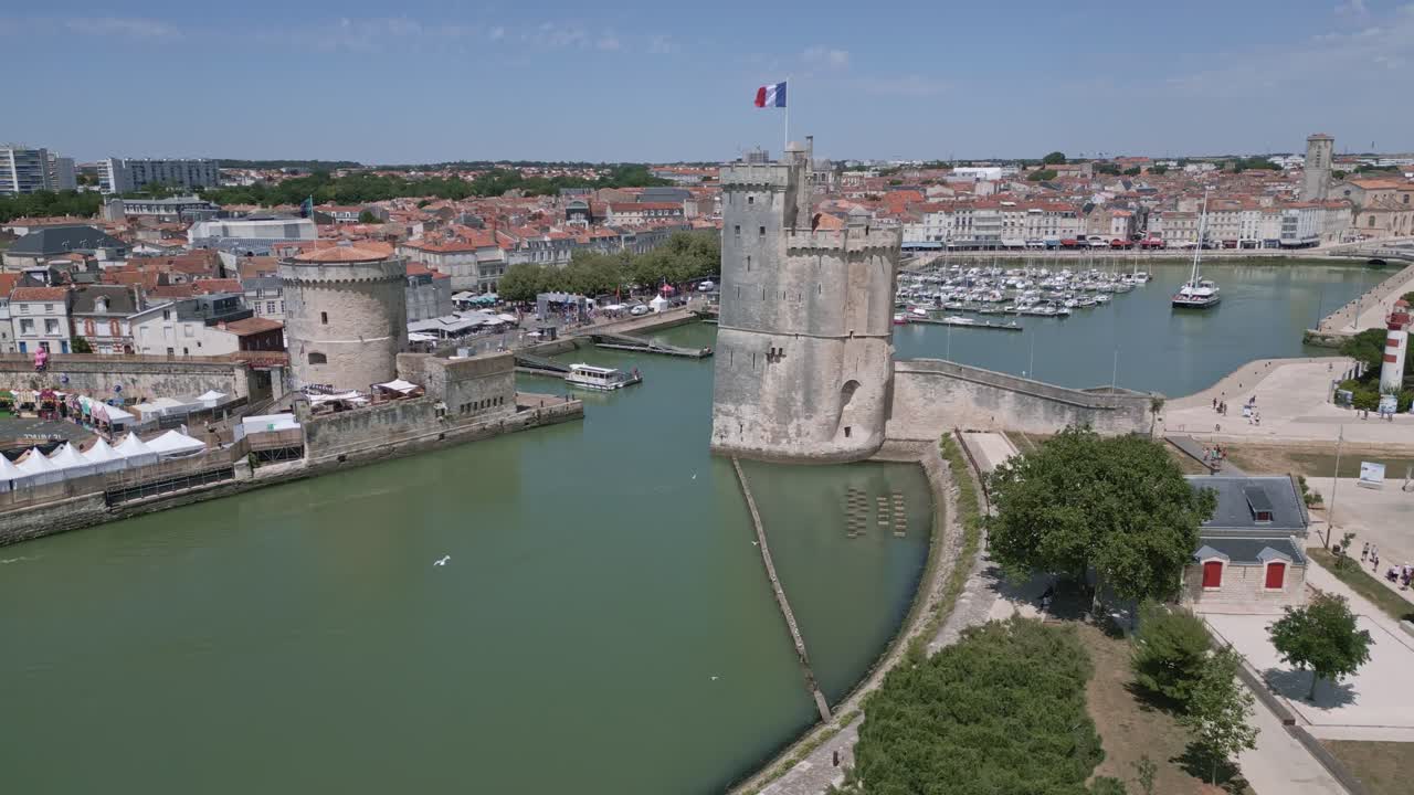Sideways drone movement near the medieval defensive Chain Tower in French coastal city, La Rochelle, France.