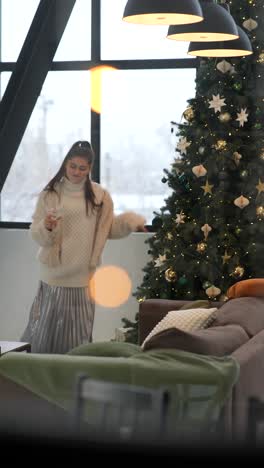 woman dancing by christmas tree