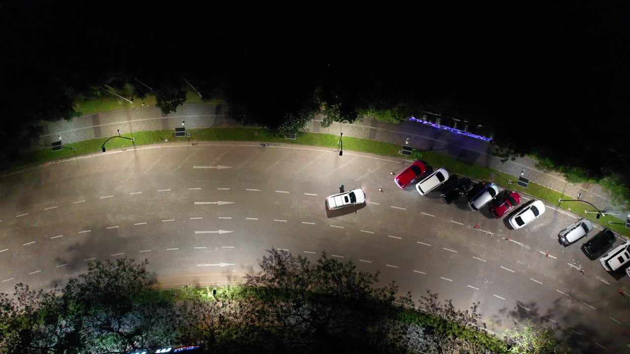 Night Aerial View of City Road with Cars and Parking