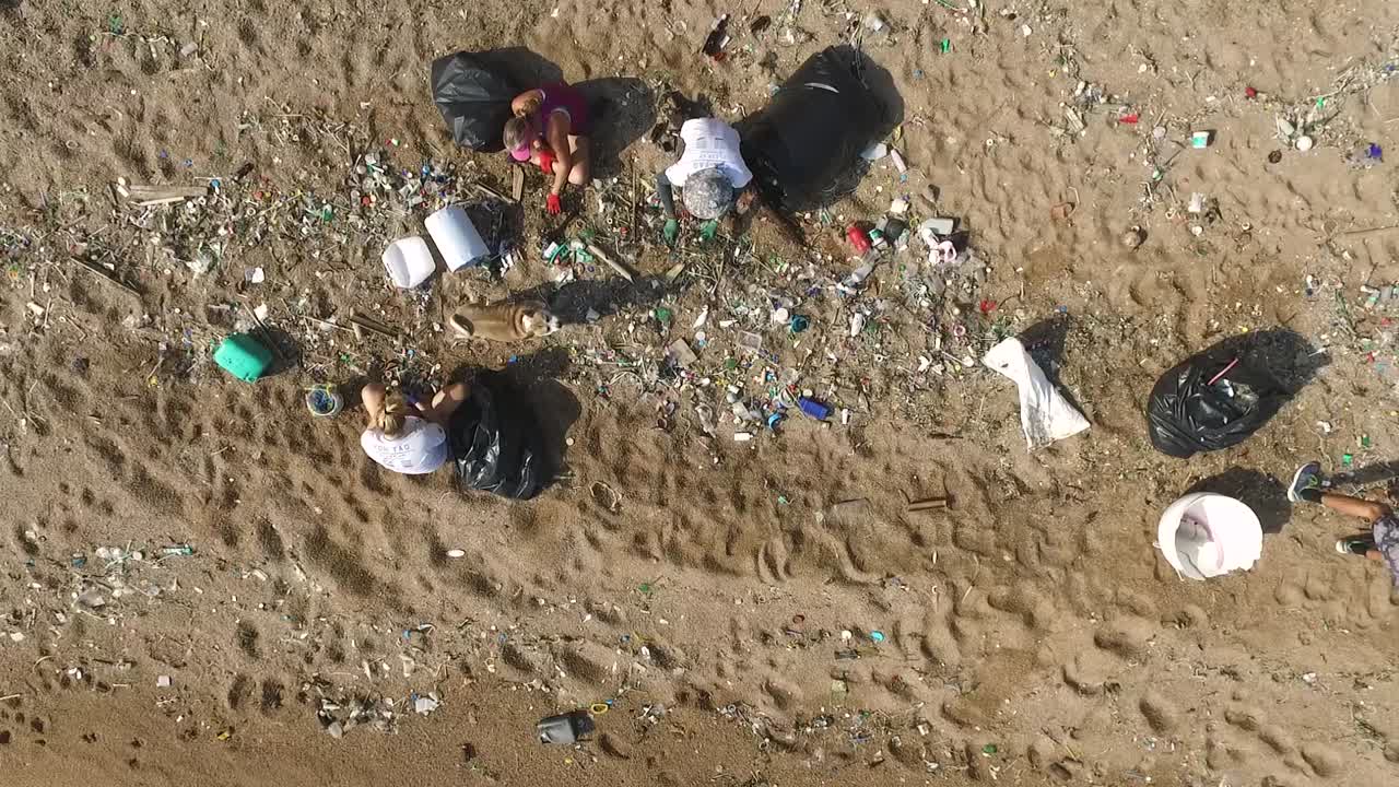 People collecting trash on beach camera point down dolly right mid shoot1080 HD Asia, Thailand Filmed with Sony AX700