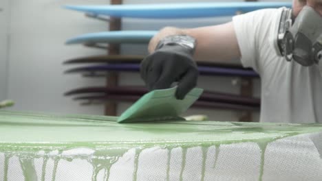 close up painting surfboard slow motion 100fps