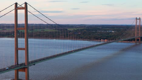 Sunset&#039;s embrace: Aerial view of Humber Bridge, cars crossing gently