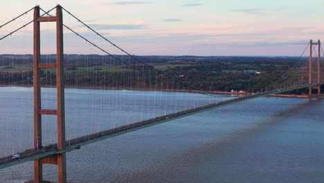 sunset's embrace: aerial view of humber bridge, cars crossing gently