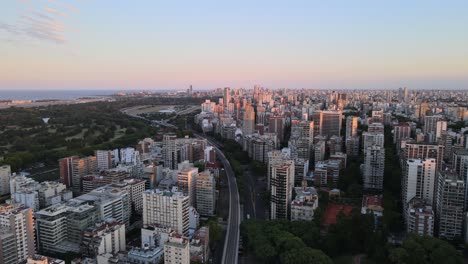 jib down of train rails surrounded by belgrano neighborhood buildings and rio de la plata river in background, buenos aires, argentina