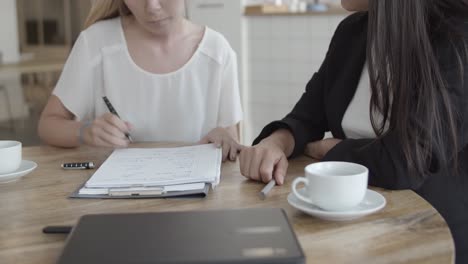 Cropped-shot-of-young-female-client-meeting-with-insurance-agent